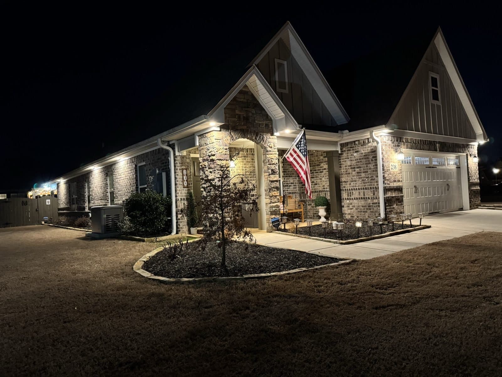 Huntsville-area home glowing at night with soffit lighting installed by Spark Medic